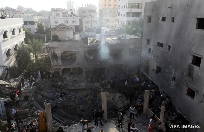 Palestinians search through the debris of the destroyed home of the al-Dallu family following an Israeli air strike in Gaza City, on November 18, 2012. Ten Palestinian civilians were killed on Sunday in an Israeli air st...