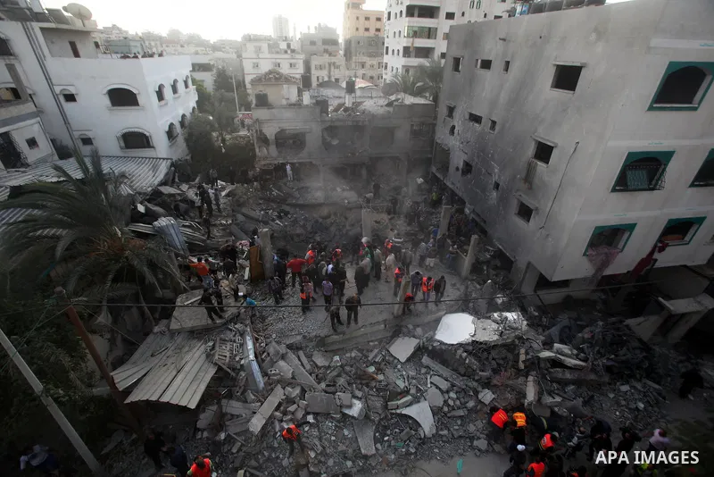 Palestinians search through the debris of the destroyed home of the al-Dallu family following an Israeli air strike in Gaza City, on November 18, 2012. Ten Palestinian civilians were killed on Sunday in an Israeli air st...