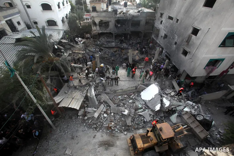 Palestinians search through the debris of the destroyed home of the al-Dallu family following an Israeli air strike in Gaza City, on November 18, 2012. Ten Palestinian civilians were killed on Sunday in an Israeli air st...