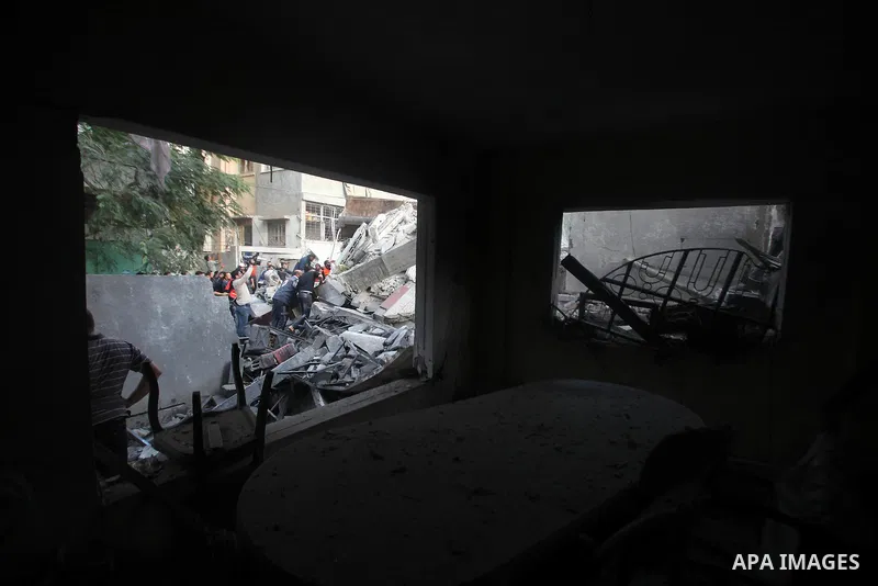 Palestinians search through the debris of the destroyed home of the al-Dallu family following an Israeli air strike in Gaza City, on November 18, 2012. Ten Palestinian civilians were killed on Sunday in an Israeli air st...