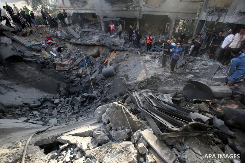 Palestinians search through the debris of the destroyed home of the al-Dallu family following an Israeli air strike in Gaza City, on November 18, 2012. Ten Palestinian civilians were killed on Sunday in an Israeli air st...