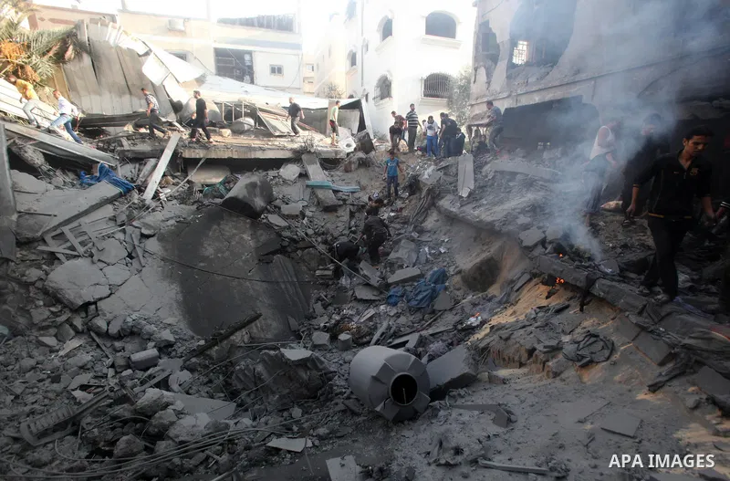 Palestinians search through the debris of the destroyed home of the al-Dallu family following an Israeli air strike in Gaza City, on November 18, 2012. Ten Palestinian civilians were killed on Sunday in an Israeli air st...