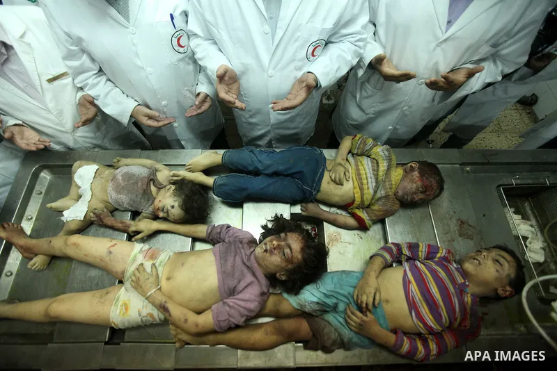Palestinian doctors gather arround the bodies of four children from the al-Dallu family lay in a hospital after an Israeli missile struck a family home in Gaza City, on November 18, 2012. Ten Palestinian civilians were k...