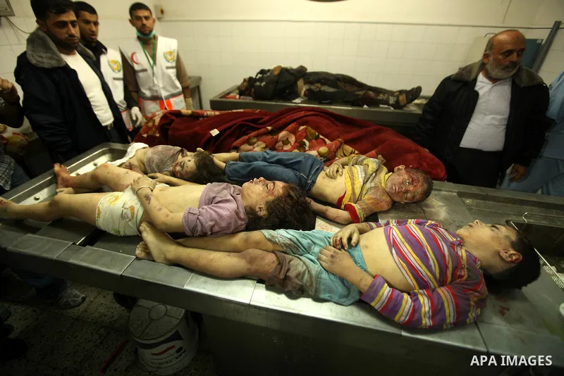 Palestinians gather arround the bodies of four children from the al-Dallu family lay in a hospital after an Israeli missile struck a family home in Gaza City, on November 18, 2012. Ten Palestinian civilians were killed o...