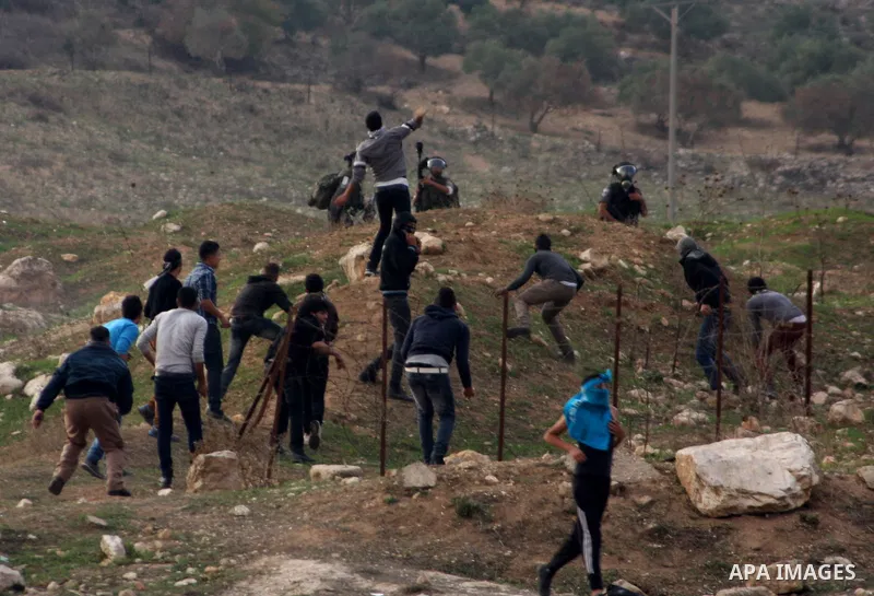 Palestinian protesters throw stones at Israeli soldiers during clashes following a protest against Israel's operations in the Gaza Strip, at Howwara checkpoint near Nablus, the West Bank, 18 November 2012. Reports state...