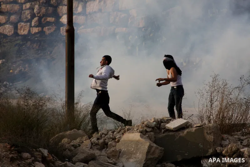 Palestinian protesters throw stones at Israeli soldiers during clashes following a protest against Israel's operations in the Gaza Strip, at Howwara checkpoint near Nablus, the West Bank, 18 November 2012. Reports state...