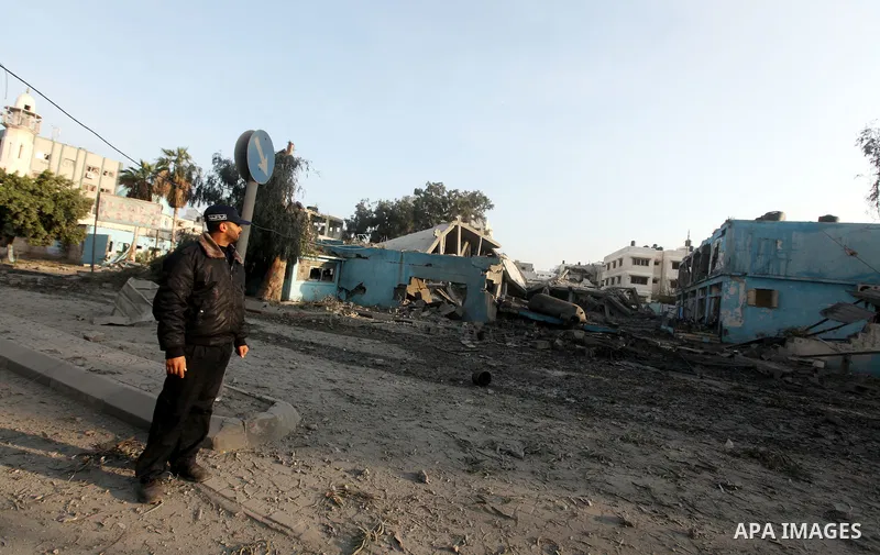 A Palestinian policeman surveys the remains of a destroyed police station after Israeli air strike in al-Shijaia in the east of Gaza city on, 19 November 2012. The Palestinian civilian death toll mounted Monday as Israel...