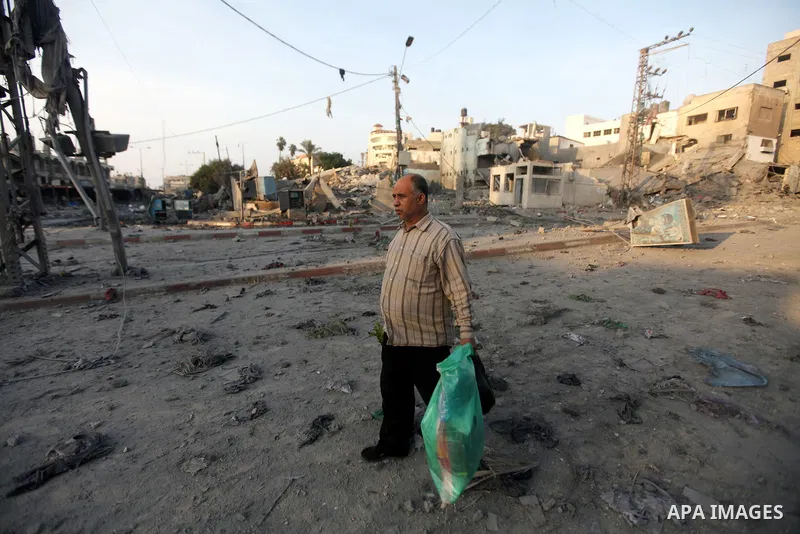 A Palestinian man surveys the remains of a destroyed police station after Israeli air strike in al-Shijaia in the east of Gaza city on, 19 November 2012. The Palestinian civilian death toll mounted Monday as Israeli airc...