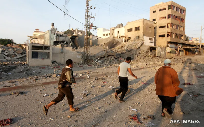 Palestinians survey the remains of a destroyed police station after Israeli air strike in al-Shijaia in the east of Gaza city on, 19 November 2012. The Palestinian civilian death toll mounted Monday as Israeli aircraft s...