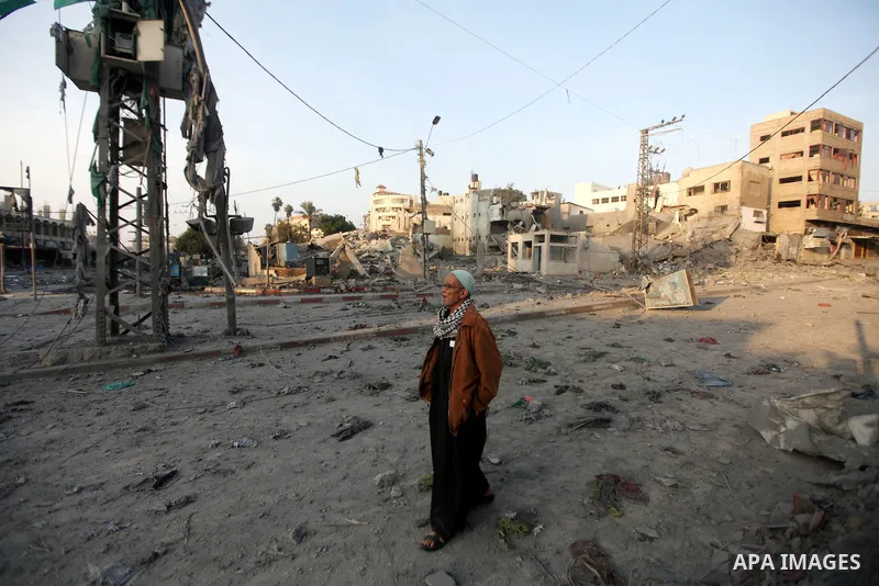 A Palestinian man surveys the remains of a destroyed police station after Israeli air strike in al-Shijaia in the east of Gaza city on, 19 November 2012. The Palestinian civilian death toll mounted Monday as Israeli airc...