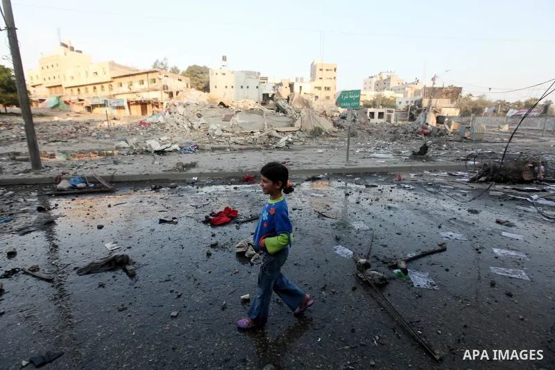A Palestinian boy surveys the remains of a destroyed police station after Israeli air strike in al-Shijaia in the east of Gaza city on, 19 November 2012. The Palestinian civilian death toll mounted Monday as Israeli airc...
