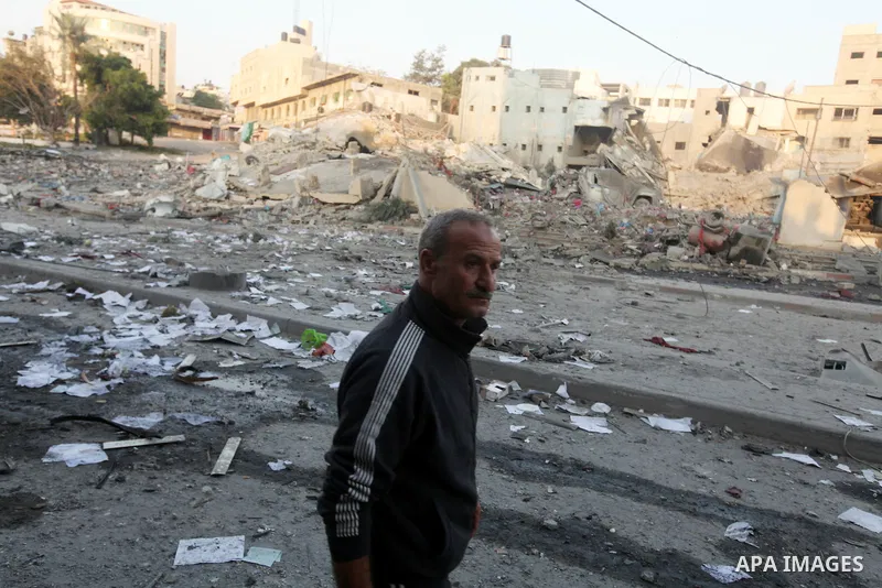 A Palestinian man surveys the remains of a destroyed police station after Israeli air strike in al-Shijaia in the east of Gaza city on, 19 November 2012. The Palestinian civilian death toll mounted Monday as Israeli airc...