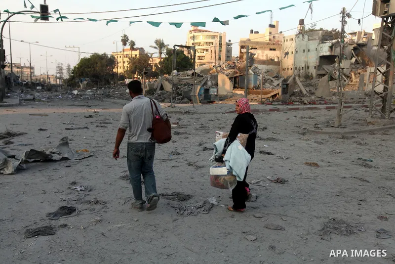 Palestinians survey the remains of a destroyed police station after Israeli air strike in al-Shijaia in the east of Gaza city on, 19 November 2012. The Palestinian civilian death toll mounted Monday as Israeli aircraft s...
