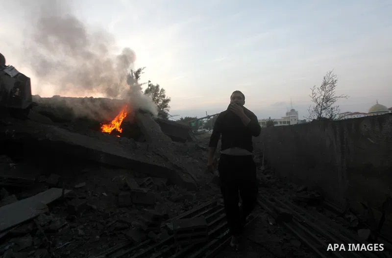 A Palestinian man walks amongst the debris of destroyed homes following an Israeli air strike in Gaza City, on November 19, 2012. Israeli air strikes on Sunday killed 31 Palestinians in the bloodiest day so far of its ai...