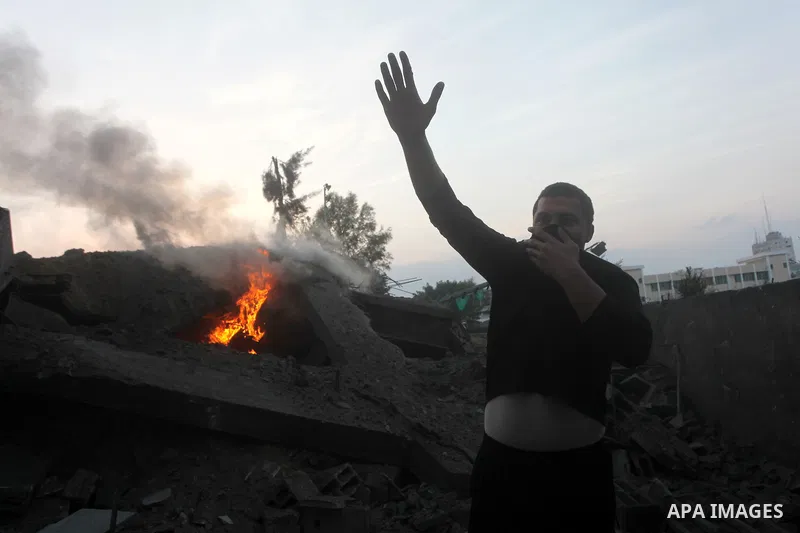 A Palestinian man stands near the debris of destroyed homes following an Israeli air strike in Gaza City, on November 19, 2012. Israeli air strikes on Sunday killed 31 Palestinians in the bloodiest day so far of its air...