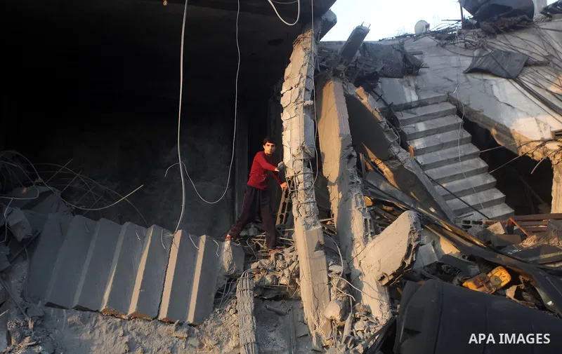Palestinians search the debris of a destroyed home following an Israeli air strike in Gaza City, on November 19, 2012. Israeli air strikes on Sunday killed 31 Palestinians in the bloodiest day so far of its air campaign...