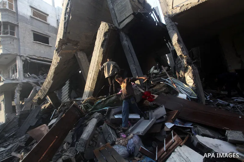 Palestinians search the debris of a destroyed home following an Israeli air strike in Gaza City, on November 19, 2012. Israeli air strikes on Sunday killed 31 Palestinians in the bloodiest day so far of its air campaign...