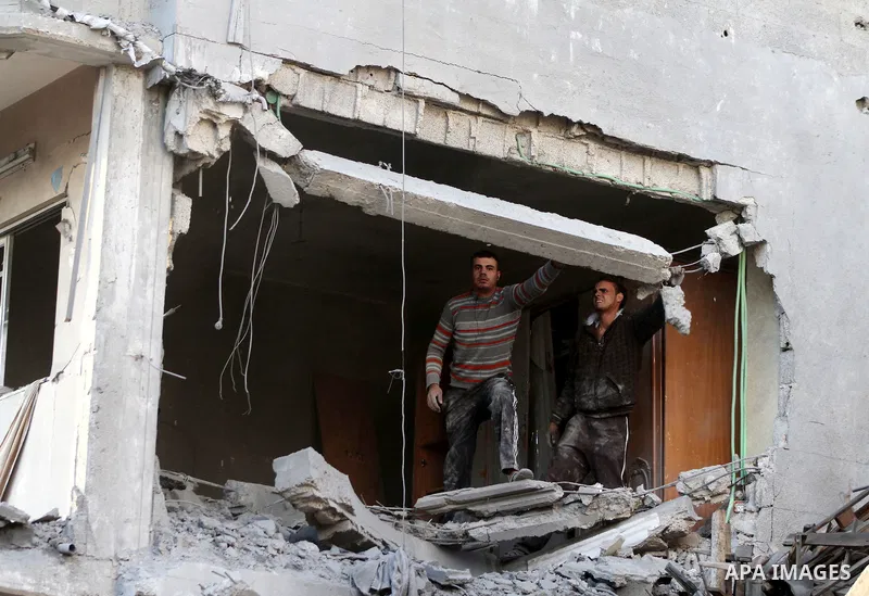 Palestinians search the debris of a destroyed home following an Israeli air strike in Gaza City, on November 19, 2012. Israeli air strikes on Sunday killed 31 Palestinians in the bloodiest day so far of its air campaign...