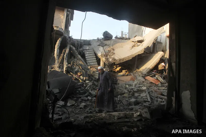 Palestinians search the debris of a destroyed home following an Israeli air strike in Gaza City, on November 19, 2012. Israeli air strikes on Sunday killed 31 Palestinians in the bloodiest day so far of its air campaign...