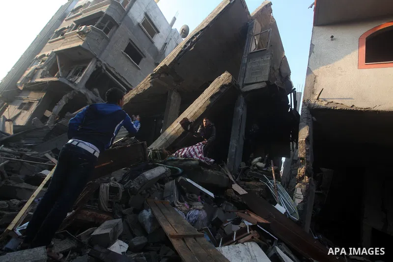 Palestinians search the debris of a destroyed home following an Israeli air strike in Gaza City, on November 19, 2012. Israeli air strikes on Sunday killed 31 Palestinians in the bloodiest day so far of its air campaign...