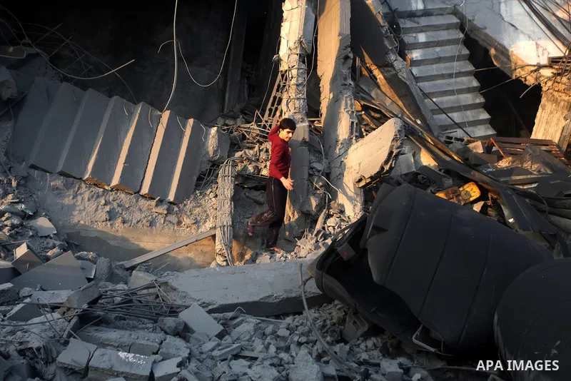 Palestinians search the debris of a destroyed home following an Israeli air strike in Gaza City, on November 19, 2012. Israeli air strikes on Sunday killed 31 Palestinians in the bloodiest day so far of its air campaign...