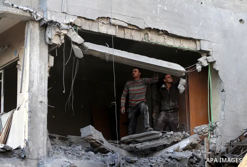 Palestinians search the debris of a destroyed home following an Israeli air strike in Gaza City, on November 19, 2012. Israeli air strikes on Sunday killed 31 Palestinians in the bloodiest day so far of its air campaign...