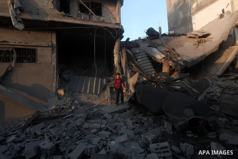 Palestinians search the debris of a destroyed home following an Israeli air strike in Gaza City, on November 19, 2012. Israeli air strikes on Sunday killed 31 Palestinians in the bloodiest day so far of its air campaign...
