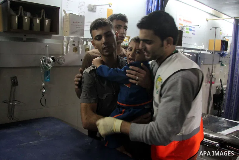 A Palestinian medic carries a wounded baby boy at al-Shifa hospital after an Israeli air strike in Gaza city, on November 19, 2012. Israeli air strikes on Sunday killed 31 Palestinians in the bloodiest day so far of its...