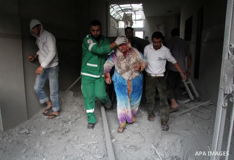 Palestinian medics treat a wounded woman after an Israeli air strike in Gaza city, on November 19, 2012. Israeli air strikes on Sunday killed 31 Palestinians in the bloodiest day so far of its air campaign on the Gaza St...