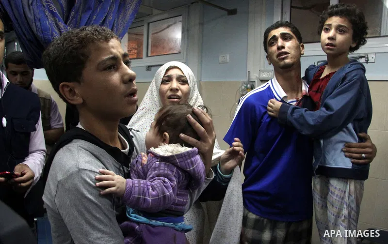 Relatives of wounded Palestinians stand on al-Shifa hospital after an Israeli air strike in Gaza city, on November 19, 2012. Israeli air strikes on Sunday killed 31 Palestinians in the bloodiest day so far of its air cam...