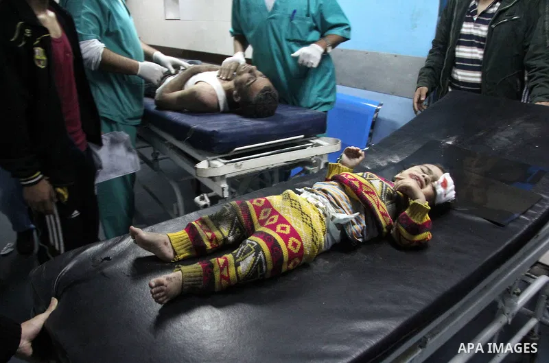 Palestinians medics treat a wounded baby boy at al-Shifa hospital after an Israeli air strike in Gaza city, on November 19, 2012. Israeli air strikes on Sunday killed 31 Palestinians in the bloodiest day so far of its ai...