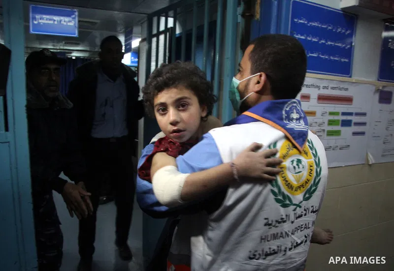 A Palestinian man carries a wounded baby boy at al-Shifa hospital after an Israeli air strike in Gaza city, on November 19, 2012. Israeli air strikes on Sunday killed 31 Palestinians in the bloodiest day so far of its ai...