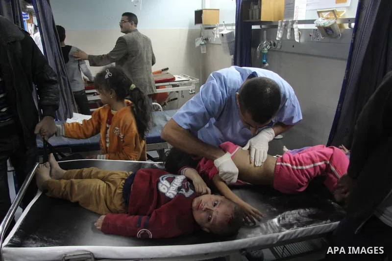 A Palestinian medic treats wounded children at al-Shifa hospital after an Israeli air strike in Gaza city, on November 19, 2012. Israeli air strikes on Sunday killed 31 Palestinians in the bloodiest day so far of its air...