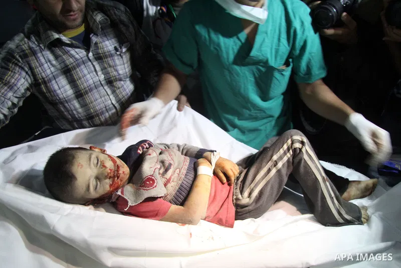 Palestinians medics carry a body of baby boy at al-Shifa hospital after an Israeli air strike in Gaza city, on November 19, 2012. Israeli air strikes on Sunday killed 31 Palestinians in the bloodiest day so far of its ai...