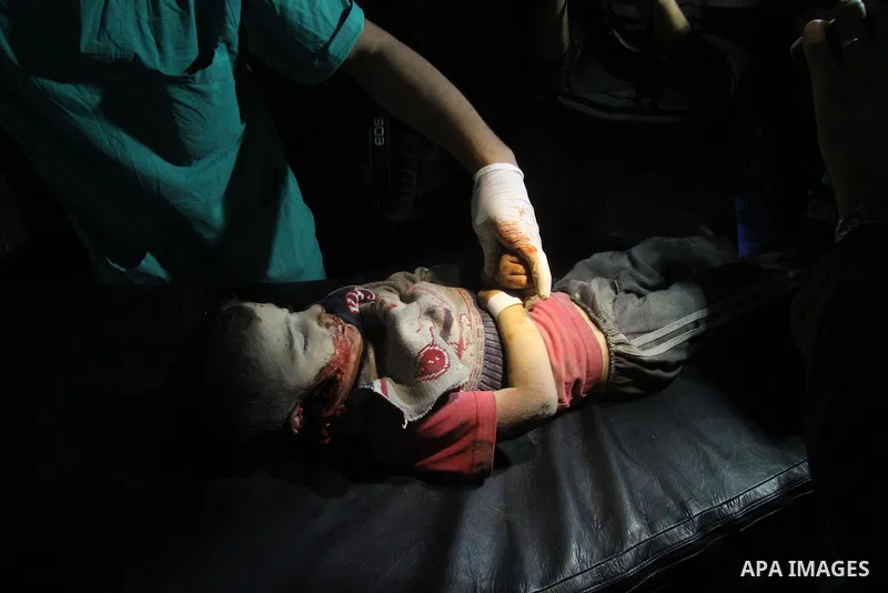 Palestinians medics carry a body of baby boy at al-Shifa hospital after an Israeli air strike in Gaza city, on November 19, 2012. Israeli air strikes on Sunday killed 31 Palestinians in the bloodiest day so far of its ai...