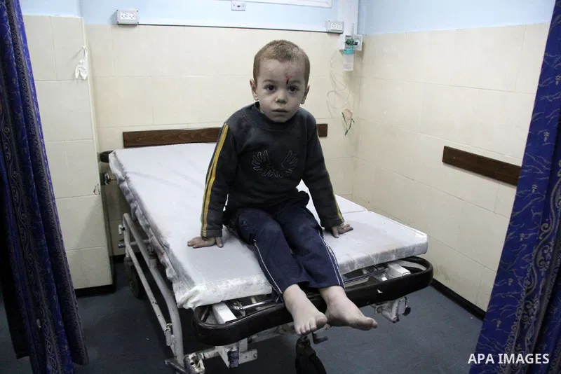 A Palestinian baby boy sits on stretcher at al-Shifa hospital after an Israeli air strike in Gaza city, on November 19, 2012. Israeli air strikes on Sunday killed 31 Palestinians in the bloodiest day so far of its air ca...
