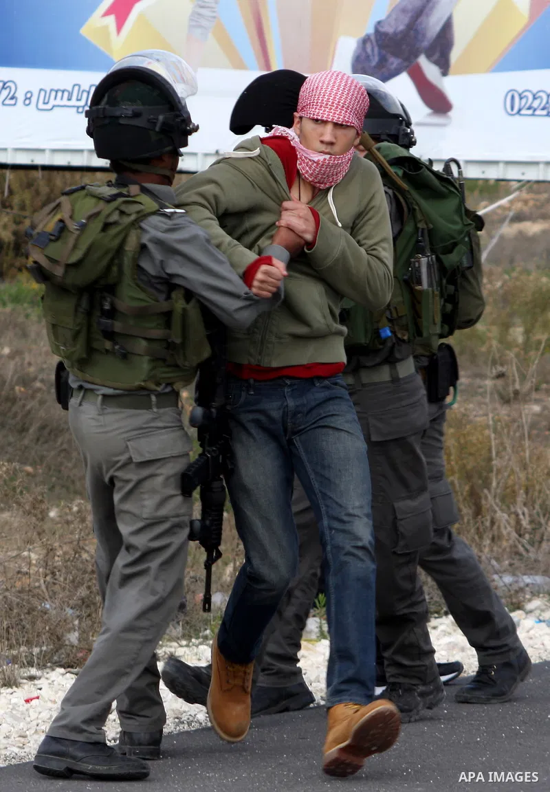 Israeli soldiers arrest a Palestinian protester during clashes following a protest against Israel's operations in the Gaza Strip, at Howwara checkpoint near Nablus, the West Bank, 17 November 2012. Reports state that the...