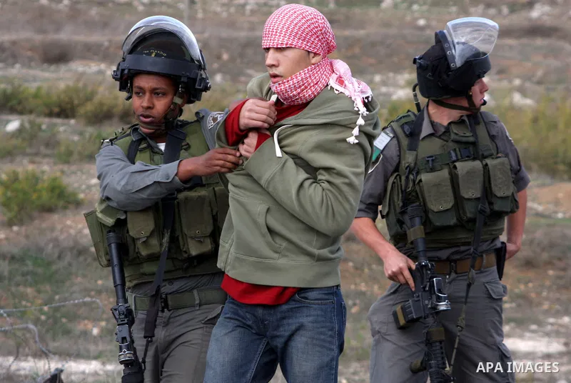 Israeli soldiers arrest a Palestinian protester during clashes following a protest against Israel's operations in the Gaza Strip, at Howwara checkpoint near Nablus, the West Bank, 17 November 2012. Reports state that the...