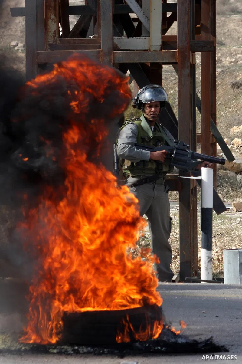An Israeli policeman shoots a tear gas canister during clashes following a protest against Israel's operations in the Gaza Strip, at Howwara checkpoint near Nablus, the West Bank, 17 November 2012. Reports state that the...
