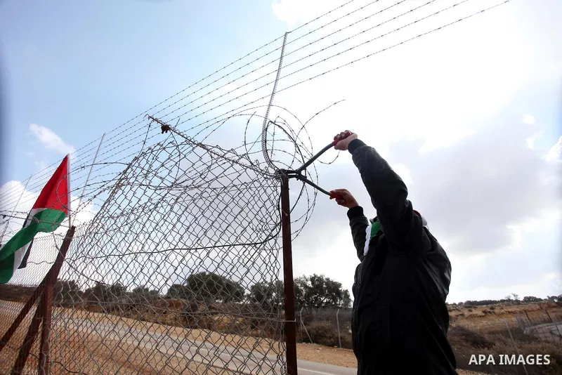 A Palestinian youth cut a section of Israel's separation fence in the West Bank village of Ramat near Ramallah to protest against Israel's military action on the Gaza Strip, on November 19, 2012 . Israeli air strikes acr...
