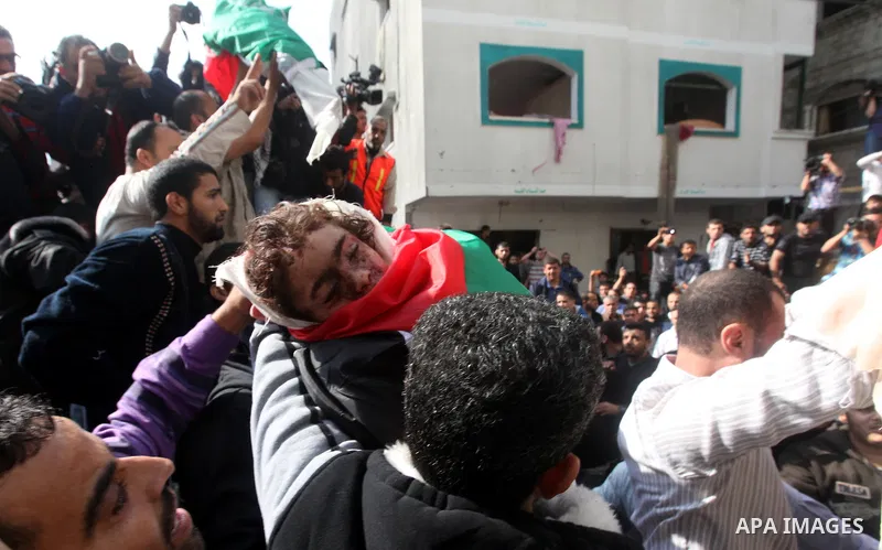 Palestinians carry the bodies of civilian from the al-Dallu family during their funeral in Gaza City, on November 19, 2012.Eleven members of the al-Dallu family were killed on Sunday when an Israeli missile struck the tw...