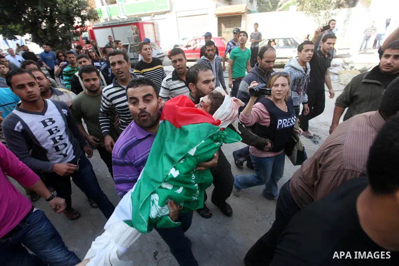 Palestinians carry the bodies of civilian from the al-Dallu family during their funeral in Gaza City, on November 19, 2012.Eleven members of the al-Dallu family were killed on Sunday when an Israeli missile struck the tw...