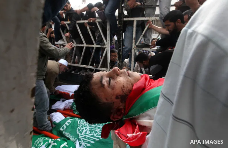 Palestinians carry the bodies of civilian from the al-Dallu family during their funeral in Gaza City, on November 19, 2012.Eleven members of the al-Dallu family were killed on Sunday when an Israeli missile struck the tw...
