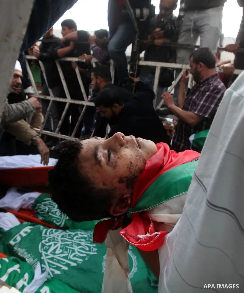 Palestinians carry the bodies of civilian from the al-Dallu family during their funeral in Gaza City, on November 19, 2012.Eleven members of the al-Dallu family were killed on Sunday when an Israeli missile struck the tw...