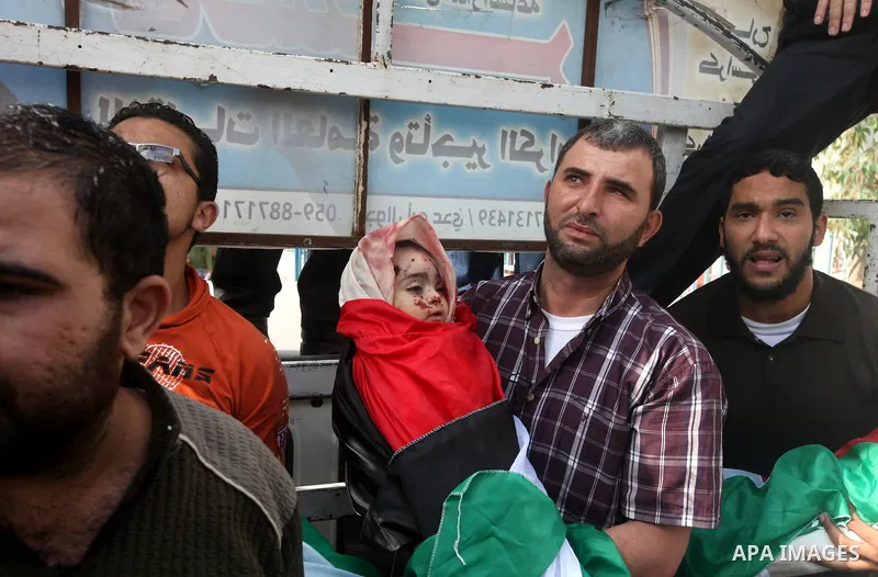 Palestinians carry the bodies of civilian from the al-Dallu family during their funeral in Gaza City, on November 19, 2012.Eleven members of the al-Dallu family were killed on Sunday when an Israeli missile struck the tw...