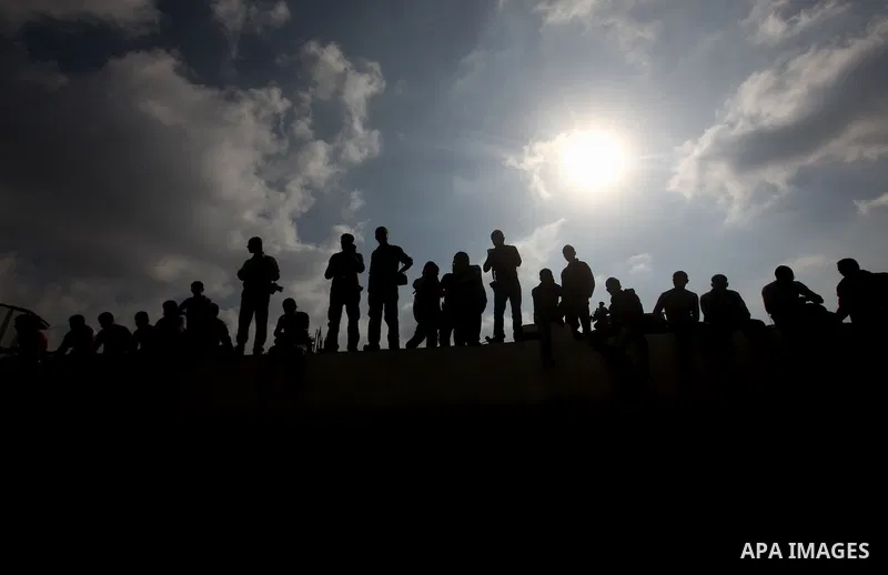 Palestinians gather over the the bodies of civilian from the al-Dallu family during their funeral in Gaza City, on November 19, 2012. Eleven members of the Dallu family were killed on Sunday when an Israeli missile struc...