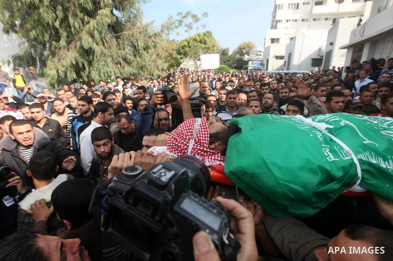 Palestinians carry the body of a member of Hamas militant Ezz el-Deen al-Qassam brigades during his funeral in Gaza City, on November 19, 2012. Media reports state that Israeli forces were on monday targeting the homes a...