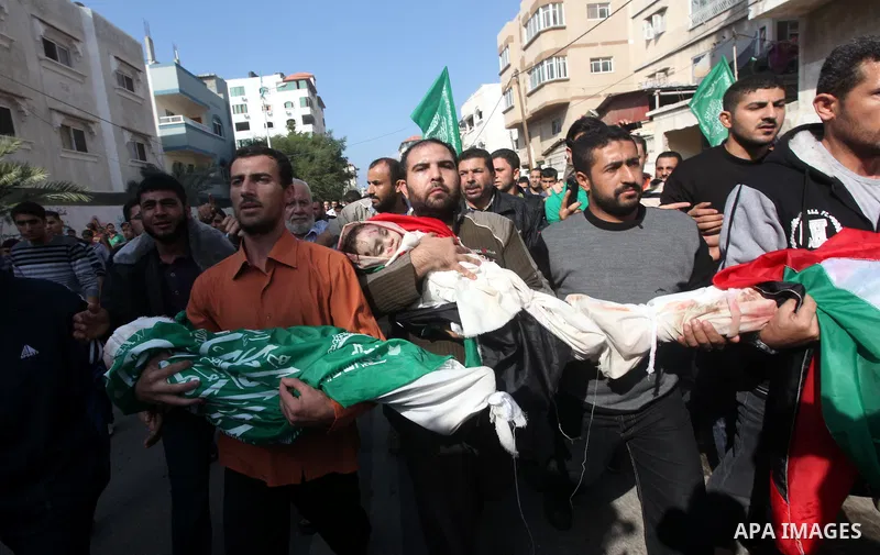 Palestinians carry the bodies of civilian from the al-Dallu family during their funeral in Gaza City, on November 19, 2012.Eleven members of the al-Dallu family were killed on Sunday when an Israeli missile struck the tw...