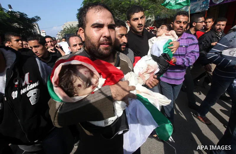 Palestinians carry the bodies of civilian from the al-Dallu family during their funeral in Gaza City, on November 19, 2012.Eleven members of the al-Dallu family were killed on Sunday when an Israeli missile struck the tw...