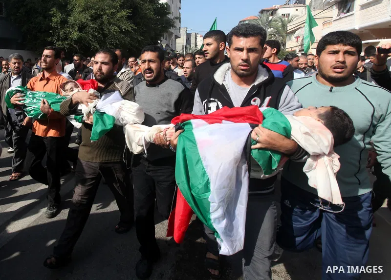 Palestinians carry the bodies of civilian from the al-Dallu family during their funeral in Gaza City, on November 19, 2012.Eleven members of the al-Dallu family were killed on Sunday when an Israeli missile struck the tw...